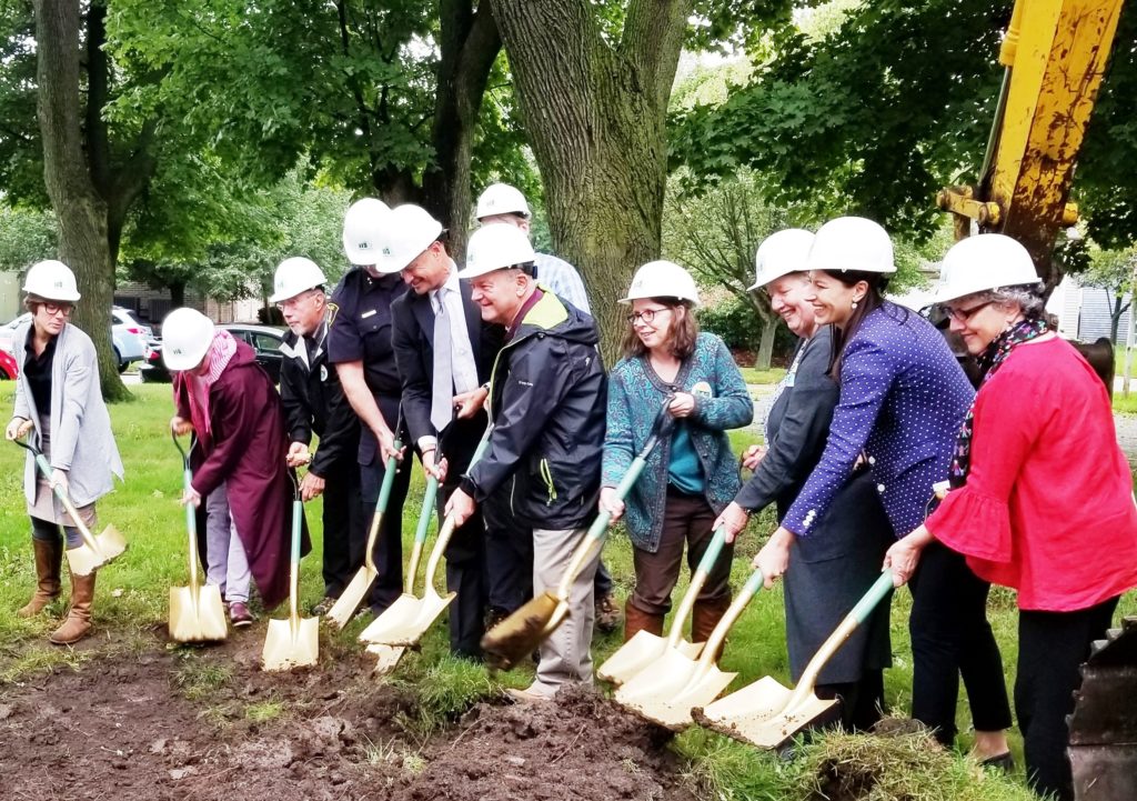 People with shovels wearing hard hats